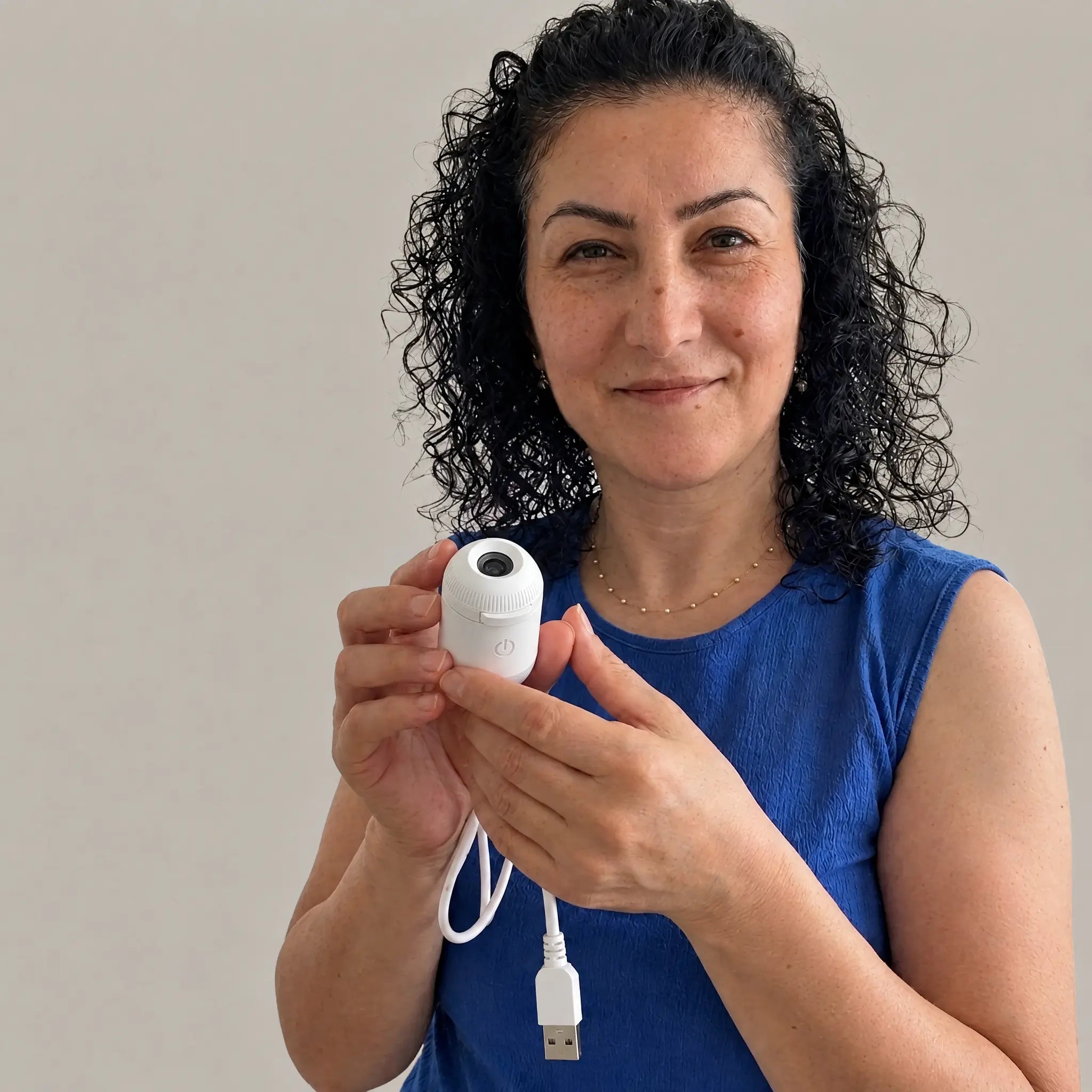 Woman holding the projector to show its size